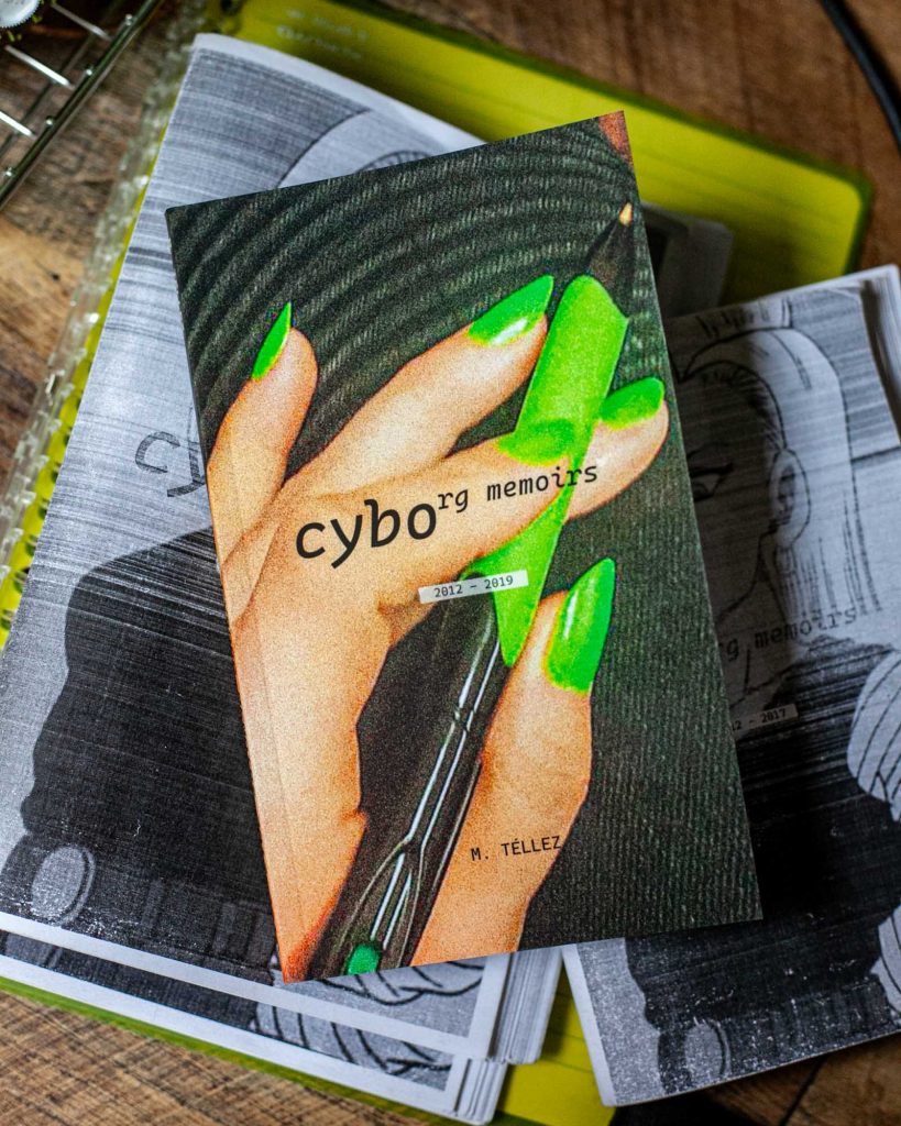 cyborg memoirs 2012-2019 book on top of two black n white draft copies 