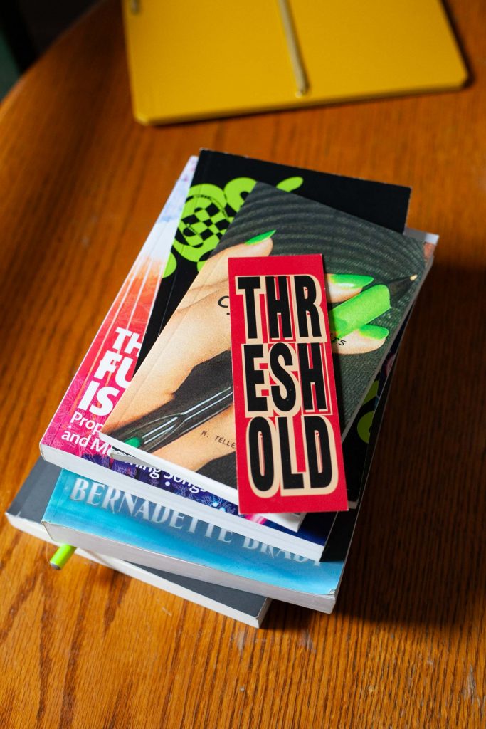 threshold bookmark on top of book pile