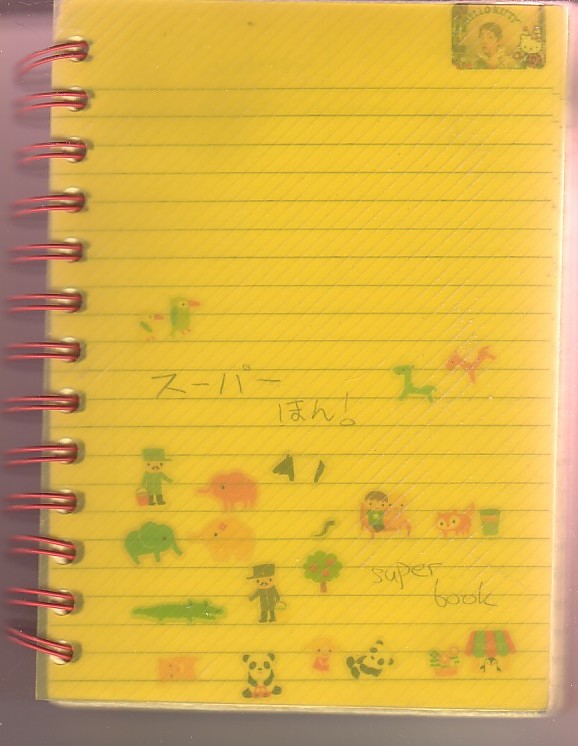 red spiral note with see-thru yellow plastic cover