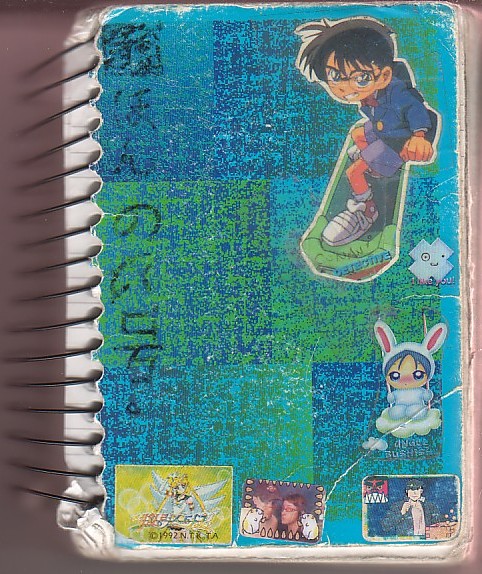 small fat spiral ring note tattered cover with stickers